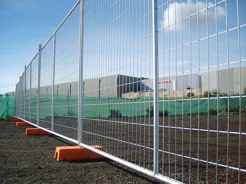 Australia temporary fence with orange fence feet.