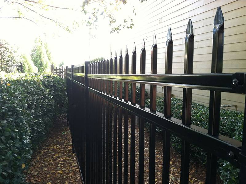 Black ornamental steel tubular fence with spear top.