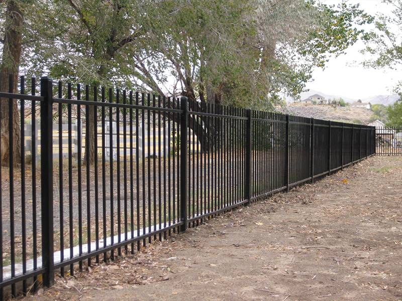 Black ornamental steel tubular fence with rod top.