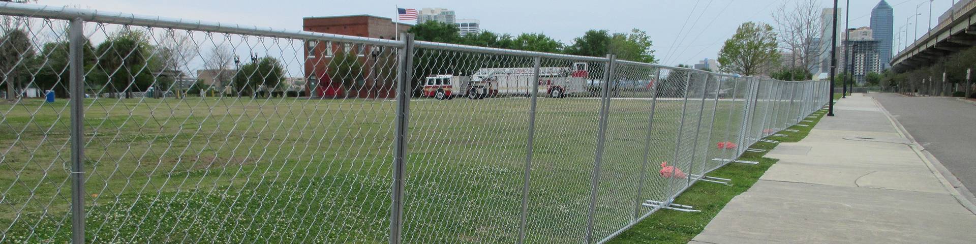 Temporary chain link fence are installed around the grassland.