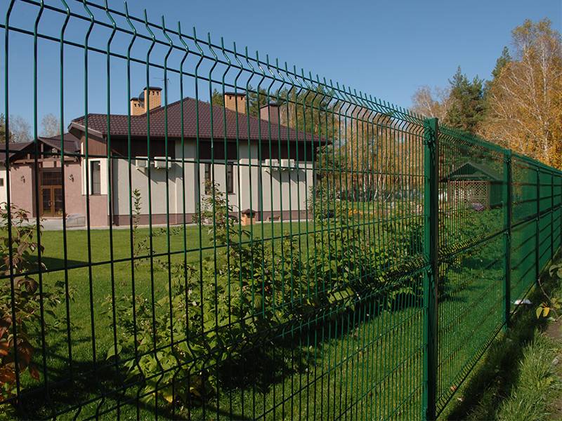 Wire mesh fences with square post surround the residence and grassland.