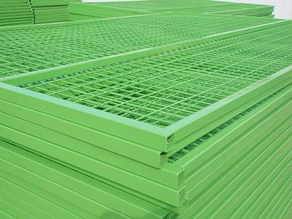 Several grass green color Canadian temporary fencing panels in the warehouse.