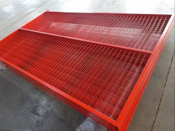 Several red color Canadian temporary fencing panels in the warehouse.