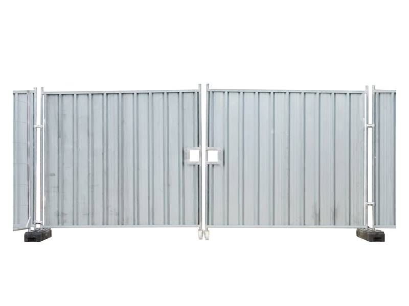 Metal hoarding gate with black rubber base and two wheels.