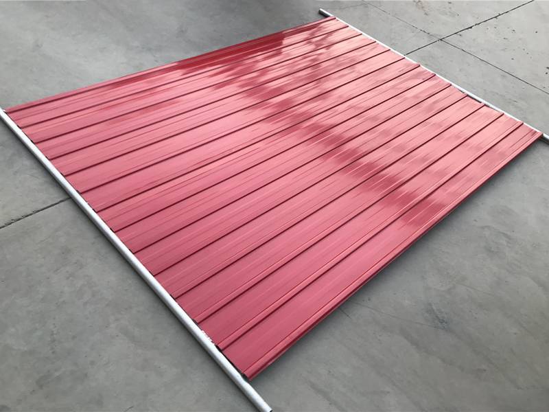 A red hoarding panel with galvanized frame on ground.