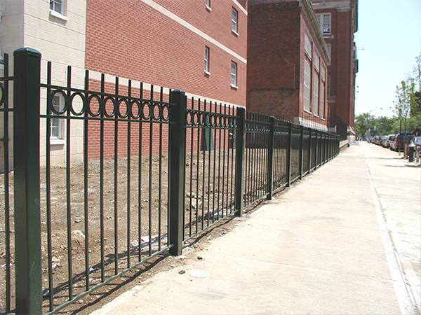 3-rail rod top steel tubular fence with decorative rings.