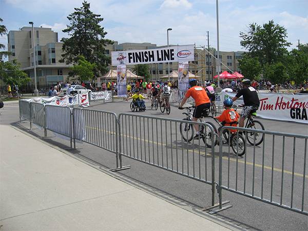 Bicycle race site with several crowd control barriers surrounding.